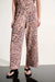 Woman wearing Joseph Ribkoff beige/multi animal print wide-leg pull-on pants styled for resort vacation, casual brunch, office chic, and evening dinner occasions.