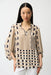 Woman wearing a dot patterned tunic top with split v-neck and 3/4 puff sleeves from Joseph Ribkoff