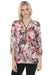 Woman wearing a floral printed 3/4 sleeve top with rhinestone-embellished zip v-neck from Joseph Ribkoff