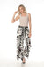Woman wearing elegant floral wide-leg pants for garden party