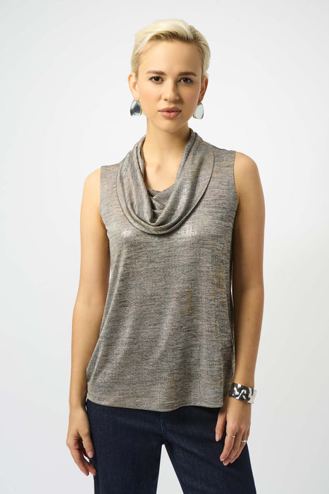 Woman wearing a metallic knit sleeveless top with cowl neck.