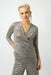 Woman wearing a metallic knit top with wrap v-neck, 3/4 sleeves, and ruching at the bodice