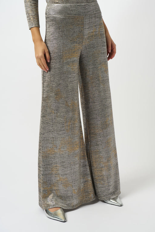 Woman wearing a metallic knit wide leg pant with high waist contour waistband