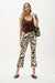Woman wearing Joseph Ribkoff beige multi tropical print flared pull-on pants with cropped length, elastic waistband, and a relaxed, modern silhouette for summer styling.