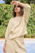 Woman wearing Joseph Ribkoff beige and off-white stripe boxy top styled for office casual, travel wear, weekend outings, and modern minimalist looks.