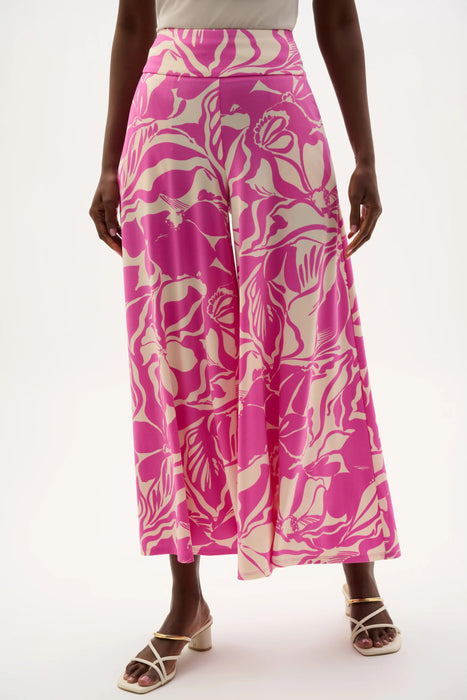 Woman wearing vibrant designer floral pants for summer outfit