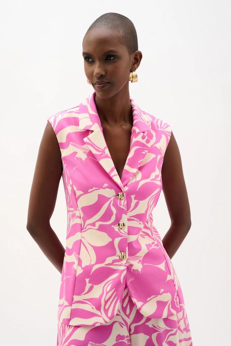 Woman wearing a beige and pink floral print sleeveless vest with a tailored fit and button-front design, styled for a chic and modern look.