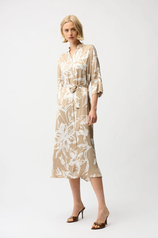Woman wearing Joseph Ribkoff beige and vanilla satin floral trapeze shirt dress with sash belt, button-down front, and elegant flowy silhouette.