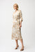Woman wearing Joseph Ribkoff beige and vanilla satin floral trapeze shirt dress with sash belt, button-down front, and elegant flowy silhouette.