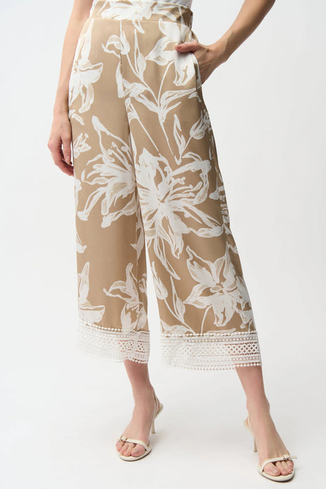 Woman wearing Joseph Ribkoff beige vanilla satin floral culotte pants with lace hem