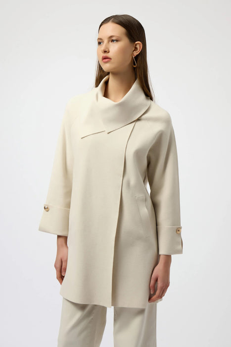 Woman wearing a beige sweater knit cardigan with overlap collar and cropped sleeves from Joseph Ribkoff