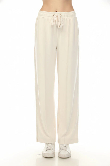 Woman wearing a cream-colored wide leg pants with drawstring elastic waistband and side pockets from Joseph Ribkoff