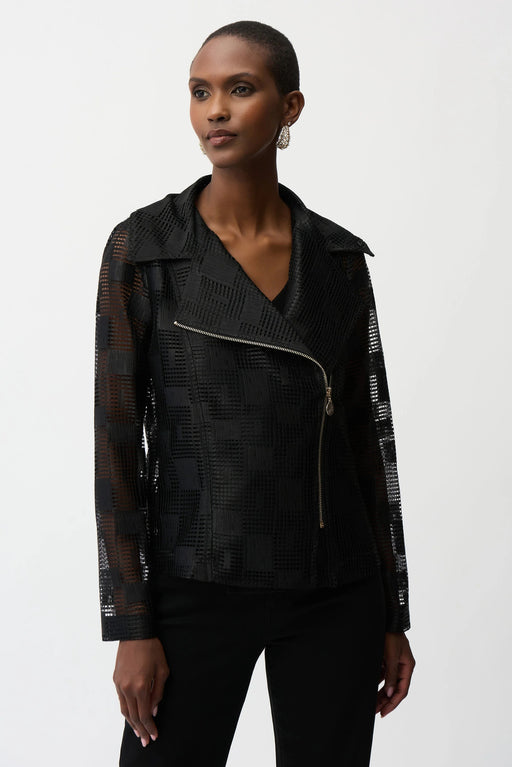 Woman wearing a black sheer textured moto jacket with asymmetric zipper and structured lapel collar, styled with black pants.