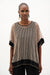 Woman wearing Joseph Ribkoff black and beige trapeze top with shimmer mesh styled for evening events, dinner outings, and elegant modern looks.