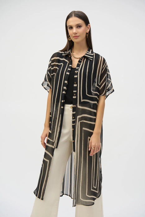 Woman wearing a long, geometric patterned sheer, chiffon blouse