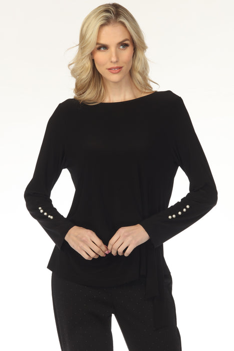 Woman wearing a black top with boat neck and long sleeves with pearl buttons accent from Joseph Ribkoff