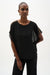 Woman wearing Joseph Ribkoff chiffon poncho top with sequined shoulder detail styled for evening wear, special occasions, and elegant casual outfits.