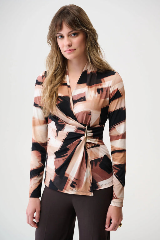 Woman wearing a black and brown abstract-patterned top with faux wrap design and long sleeves from Joseph Ribkoff