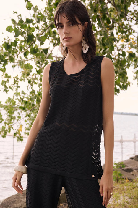 Woman wearing Joseph Ribkoff chevron stitch relaxed tunic top styled for layering, office casual looks, summer wear, and modern minimalist outfits.