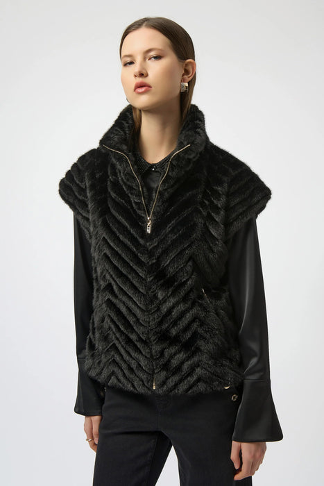 Woman wearing a black faux fur vest with chevron pattern