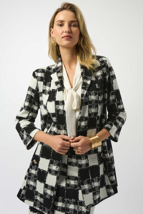 Woman wearing a black and white checkered blazer jacket