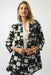 Woman wearing a black and white checkered blazer jacket