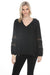 Woman wearing Joseph Ribkoff crochet sleeve tunic top for elegant office outfit