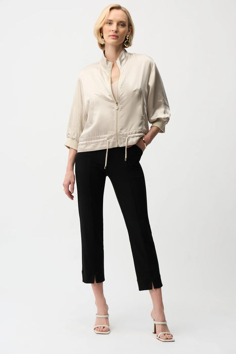 Woman wearing Joseph Ribkoff black crop pull-on pants, featuring a sleek stretch fit, cropped length, and minimalist design for modern versatile styling.