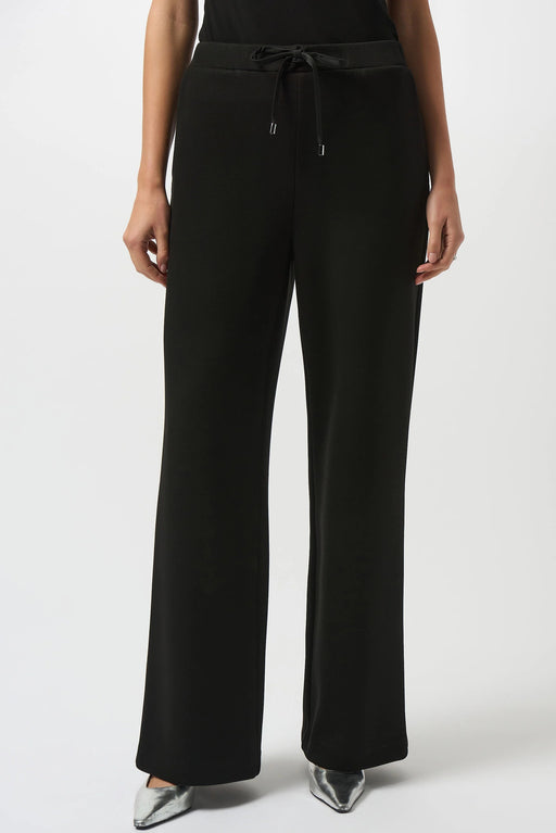 Model wearing a black wide leg pant with drawstring pull on waistband and side pockets from Joseph Ribkoff