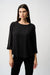 Woman wearing a black lightweight blouse with contrasting rhinestone embellishments on the 3/4 sleeves