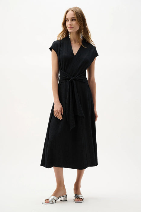 Woman wearing Joseph Ribkoff fit and flare midi dress with waist sash styled for weddings, special occasions, and elegant evening events.