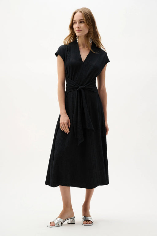 Woman wearing Joseph Ribkoff fit and flare midi dress with waist sash styled for weddings, special occasions, and elegant evening events.