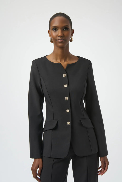 Woman wearing a black fitted jacket with button front and long sleeves