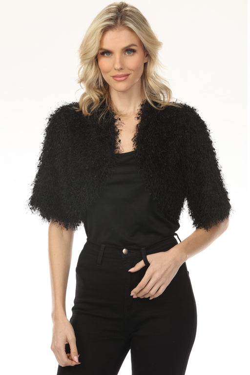 Woman wearing a black textured fringe shrug with an open front and short sleeves from Joseph Ribkoff