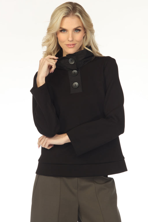 Woman wearing a black long sleeve top with funnel neck and three button closure from Joseph Ribkoff