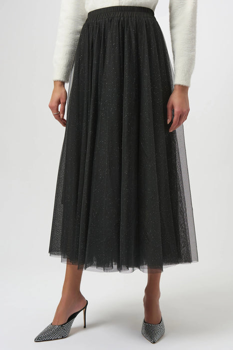 Woman wearing a black glittered tulle maxi skirt from Joseph Ribkoff