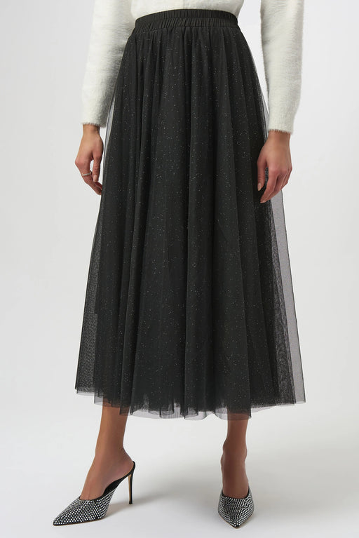 Woman wearing a black glittered tulle maxi skirt from Joseph Ribkoff