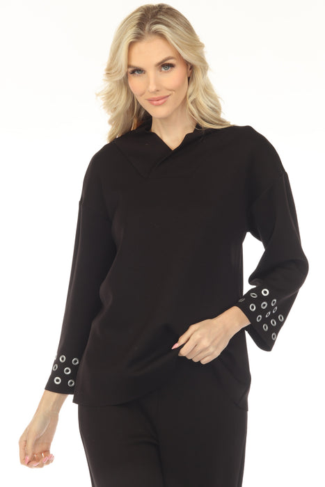 Woman wearing a black top with 3/4 sleeves and grommet detail cuffs from Joseph Ribkoff