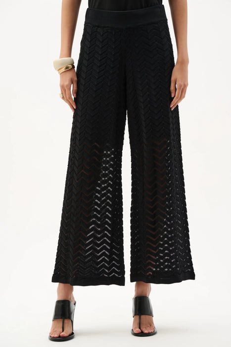 Woman wearing Joseph Ribkoff black knit chevron stitch culotte pants styled for office wear, evening outings, travel, and elevated casual occasions.