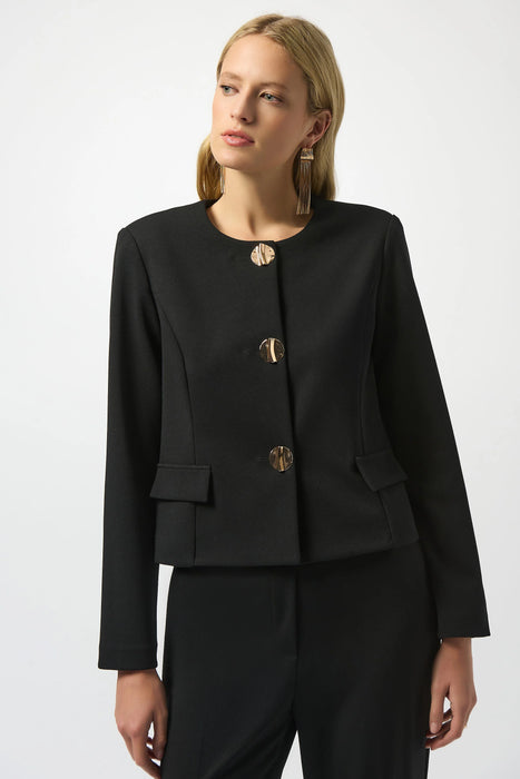Woman wearing a black solid color blazer jacket with statement button front and long sleeves