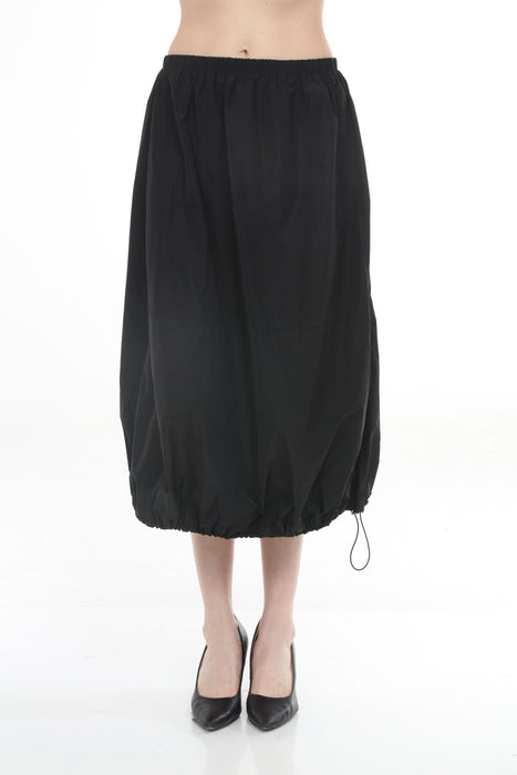 Woman wearing Joseph Ribkoff balloon skirt for modern city outfit