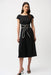 Woman wearing a black midi dress with sash and buckle detail from Joseph Ribkoff