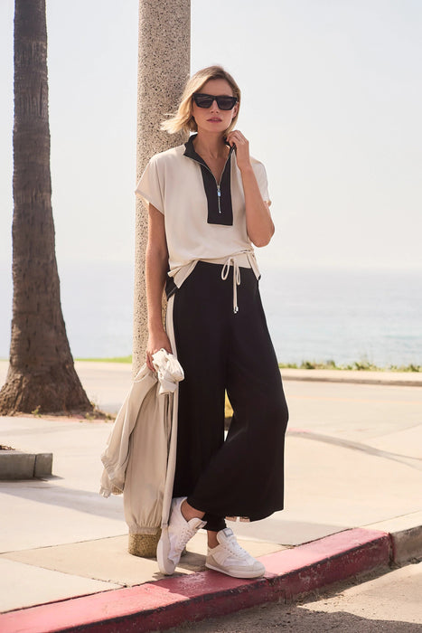 Woman wearing black wide leg pants with color block design from Joseph Ribkoff