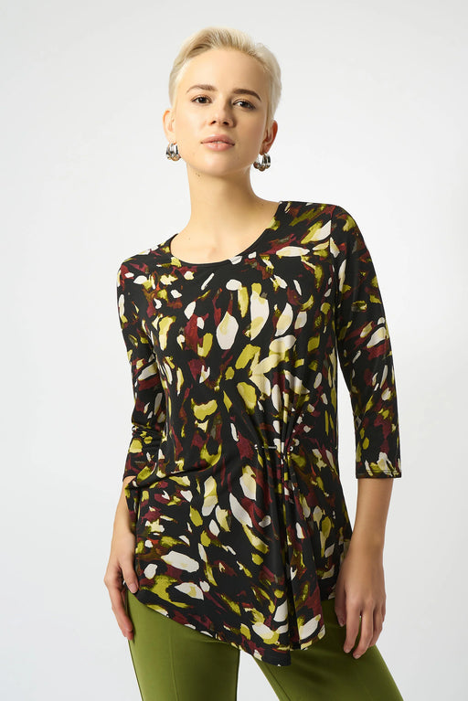 Woman wearing an abstract patterned tunic top with gathered front detail and asymmetric hem