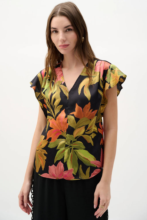 Woman wearing Joseph Ribkoff black and multi butterfly sleeves tropical top styled for resort wear, summer outings, vacation, and casual chic occasions.