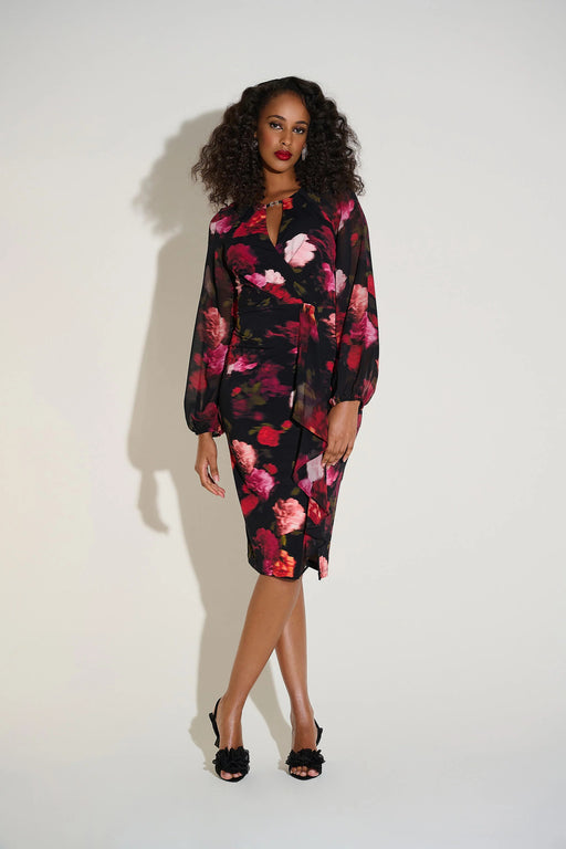 Woman wearing a floral dress with chiffon puff sleeves and cascading ruffles