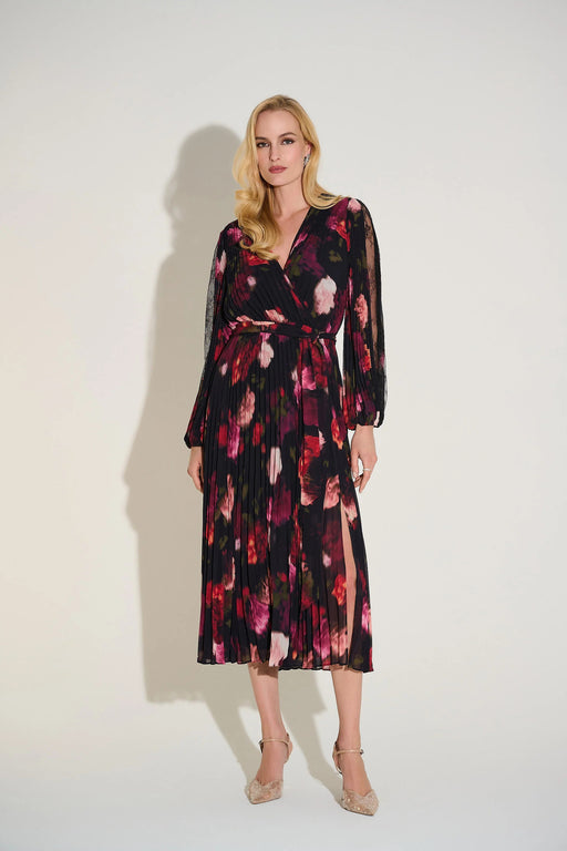 Woman wearing a chiffon pleated midi fit and flare dress with floral print