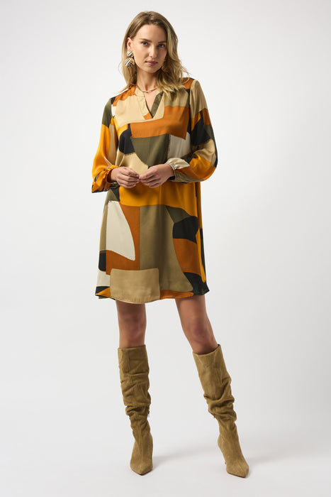 Woman wearing a geometric patterned dress with long puff sleeves