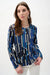 Woman wearing Joseph Ribkoff black multi geometric print fitted zip jacket