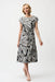 Model wearing Joseph Ribkoff black multi tropical print silky knit fit and flare dress with waist tie and short sleeves for a flattering feminine silhouette.